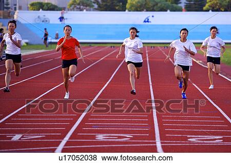 Stock Photo - Five female athletes running on race track. Fotosearch