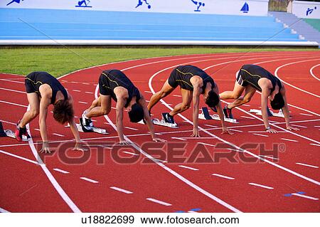 Five male athletes in starting position on track starting blocks View Large Photo Image Stock Photo - Five male athletes in starting position on track starting blocks. Fotosearch