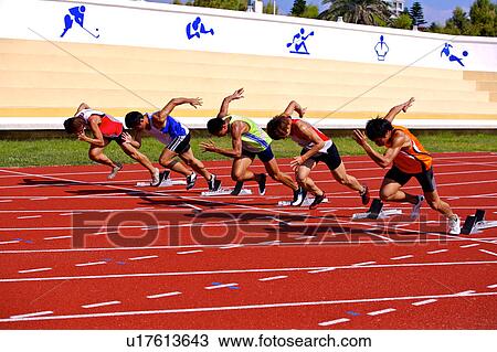 Stock Image - Five male athletes running on race track. Fotosearch