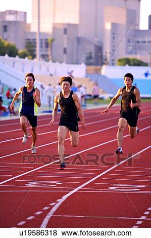 Stock Photo - Five male athletes running on race track. Fotosearch
