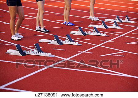 Four female athletes standing behind track starting block View Large Photo Image Stock Image - Four female athletes standing behind track starting block. Fotosearch