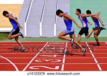 Stock Photograph - Four male athletes reaching finish line. Fotosearch
