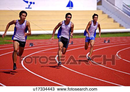 Stock Image - Three athletes running on race track. Fotosearch