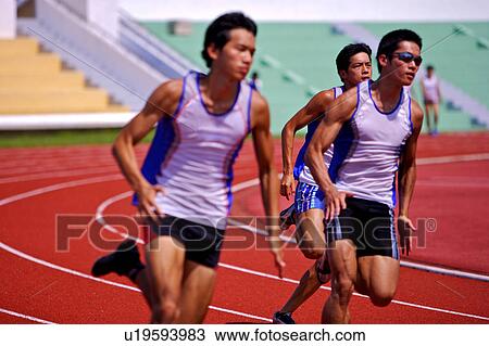Three male athletes running on race track View Large Photo Image Stock Image - Three male athletes running on race track. Fotosearch