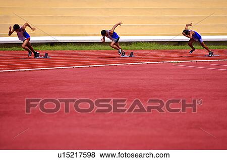 Stock Photo - Three male athletes running on race track. Fotosearch