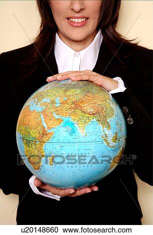 A woman holding a globe View Large Photo Image Stock Image - A woman holding a globe . Fotosearch