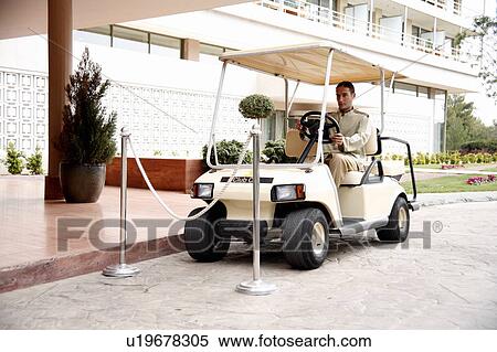 Bellboy driving hotel cart View Large Photo Image Stock Photography - Bellboy driving hotel cart. Fotosearch