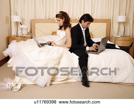 Bride and groom on laptops View Large Photo Image Stock Photo - Bride and groom on laptops. Fotosearch