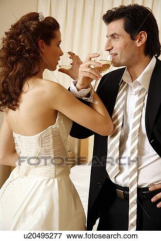 Bride and groom toasting in hotel room View Large Photo Image Stock Photo - Bride and groom toasting in hotel room. Fotosearch