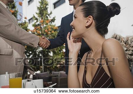 Business people meeting in garden cafe View Large Photo Image Picture - Business people meeting in garden cafe. Fotosearch