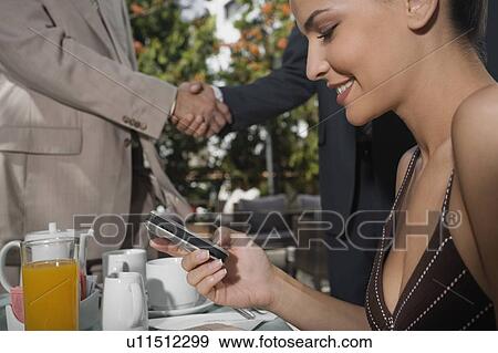 Stock Photo - Business people meeting in garden cafe. Fotosearch