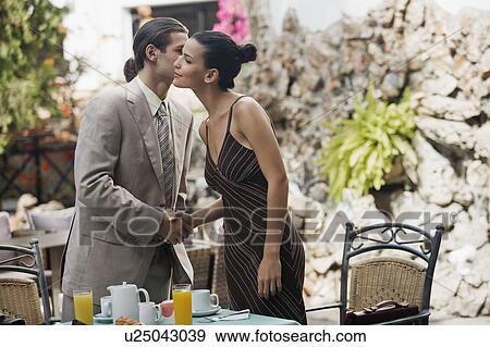 Businessman and businesswoman in garden cafe shaking hands View Large Photo Image Stock Photo - Businessman and businesswoman in garden cafe shaking hands. Fotosearch