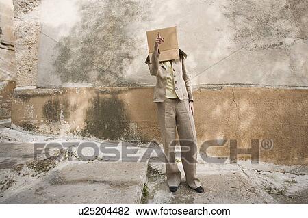 Stock Image - Businesswoman with head in a box. Fotosearch