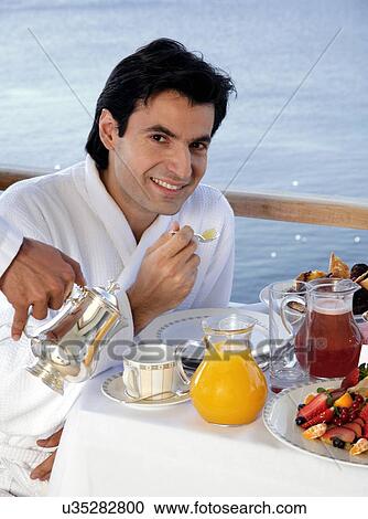 Man having breakfast on hotel terrace View Large Photo Image Stock Image - Man having breakfast on hotel terrace. Fotosearch