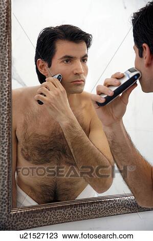Man shaving in the bathroom mirror View Large Photo Image Stock Image - Man shaving in the bathroom mirror. Fotosearch