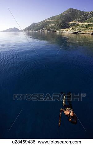 Stock Photograph - Man snorkeling in the sea. Fotosearch