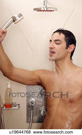 Stock Photo - Man taking a shower at the gym. Fotosearch