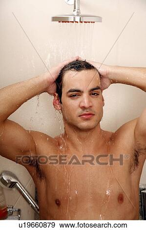 Stock Photo - Man taking a shower at the gym. Fotosearch