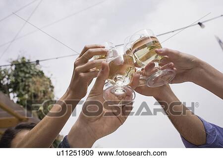 People's hands toasting with white wine View Large Photo Image Stock Photo - People's hands toasting with white wine. Fotosearch