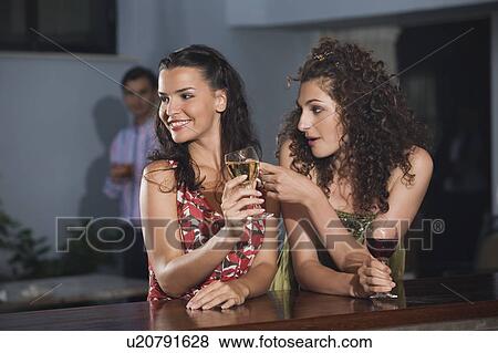 Two women in a bar View Large Photo Image Stock Photo - Two women in a bar. Fotosearch