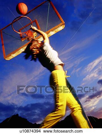 Picture - Woman playing basketball. Fotosearch