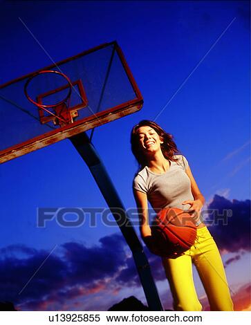 Stock Photography - Woman playing basketball. Fotosearch