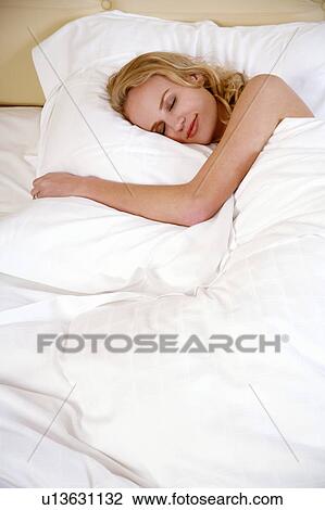 Woman sleeping in bed View Large Photo Image Stock Image - Woman sleeping in bed. Fotosearch