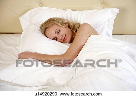 Woman sleeping in bed View Large Photo Image Stock Image - Woman sleeping in bed. Fotosearch