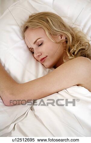 Stock Photography - Woman sleeping in bed. Fotosearch