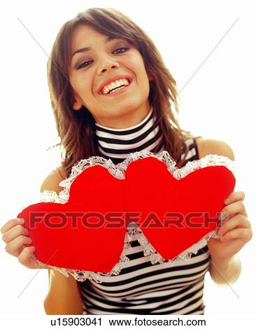 Young woman with hearts pillow View Large Photo Image Stock Image - Young woman with hearts pillow. Fotosearch