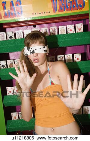 Blindfolded female teenager at game in amusement park View Large Photo Image Stock Photograph - Blindfolded female teenager at game in amusement park. Fotosearch