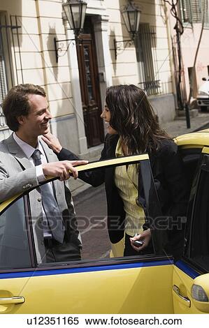 Stock Photography - Businessman and woman meeting on street. Fotosearch
