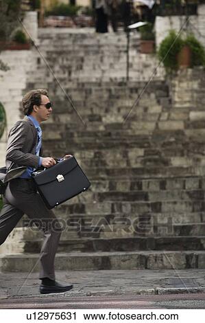 Stock Image - Businessman running. Fotosearch