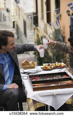 Businessmen at taverna with backgammon and ouzo View Large Photo Image Picture - Businessmen at taverna with backgammon and ouzo. Fotosearch