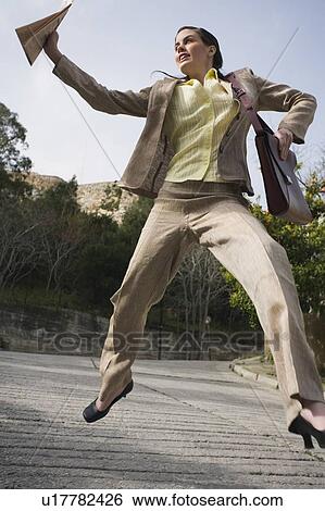 Stock Photograph - Businesswoman leaping. Fotosearch