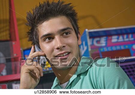 Closeup of male teenager on cell phone View Large Photo Image Stock Photograph - Closeup of male teenager on cell phone. Fotosearch