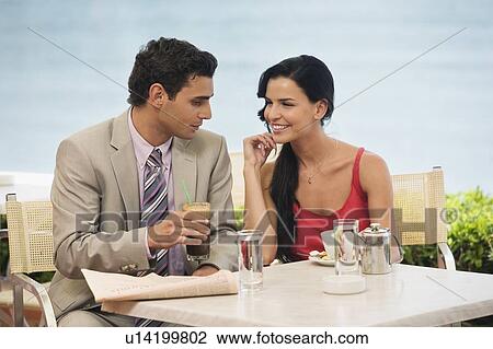 Couple at seaside cafe table View Large Photo Image Stock Image - Couple at seaside cafe table. Fotosearch