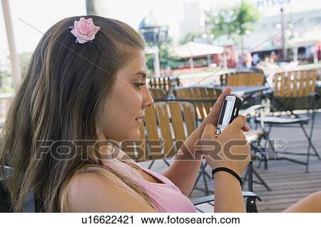Stock Image - Female teenager on cell phone. Fotosearch