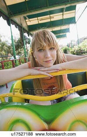 Female teenager posing at amusement park ride View Large Photo Image Stock Photo - Female teenager posing at amusement park ride. Fotosearch