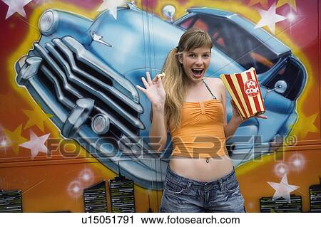 Stock Image - Female teenager posing in amusement park. Fotosearch