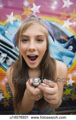 Female teenager with mp3 player in front of graffiti View Large Photo Image Stock Image - Female teenager with mp3 player in front of graffiti. Fotosearch