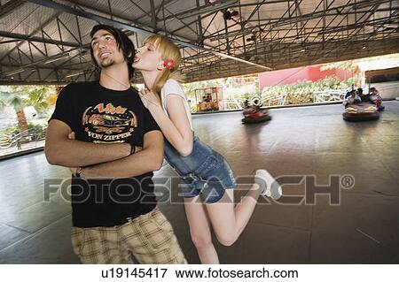 Stock Photo - Female teenager with mp3 player in front of graffiti. Fotosearch