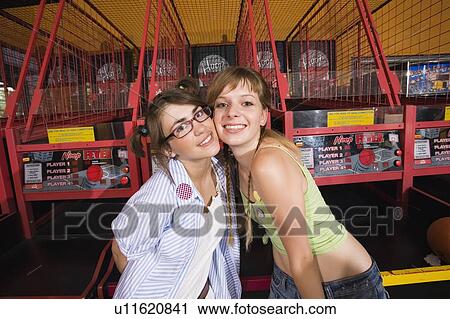 Female teenagers posing at game in arcade View Large Photo Image Stock Image - Female teenagers posing at game in arcade. Fotosearch