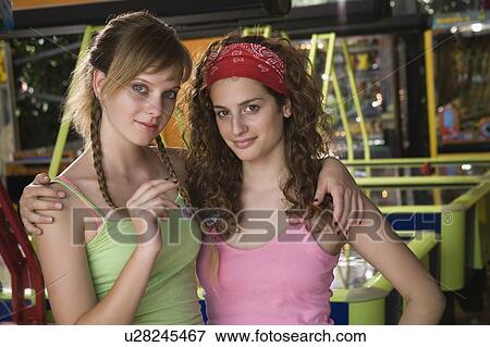 Female teenagers posing at game in arcade View Large Photo Image Stock Photo - Female teenagers posing at game in arcade. Fotosearch