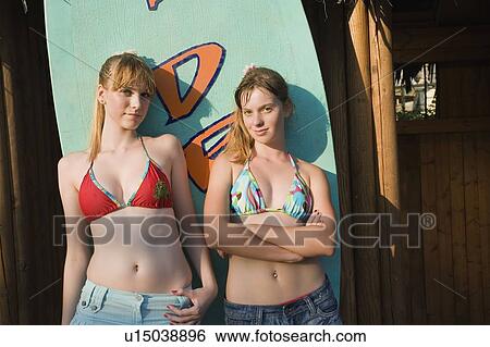 Stock Photograph - Female teenagers posing in amusement park. Fotosearch