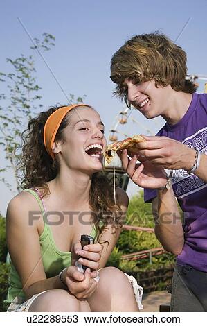 Male teenager feeding female teenager pizza View Large Photo Image Stock Image - Male teenager feeding female teenager pizza. Fotosearch
