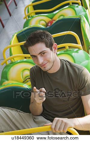 Male teenager posing on amusement park ride View Large Photo Image Stock Image - Male teenager posing on amusement park ride. Fotosearch