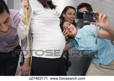 Office colleagues photographing at party with pregnant colleague View Large Photo Image Stock Image - Office colleagues photographing at party with pregnant colleague. Fotosearch