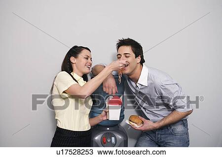 Office worker feeding her colleague View Large Photo Image Stock Image - Office worker feeding her colleague. Fotosearch
