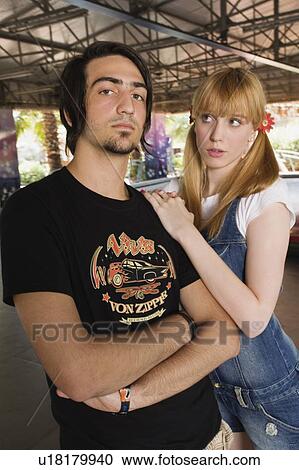 Teenage couple at game in amusement park View Large Photo Image Stock Image - Teenage couple at game in amusement park. Fotosearch